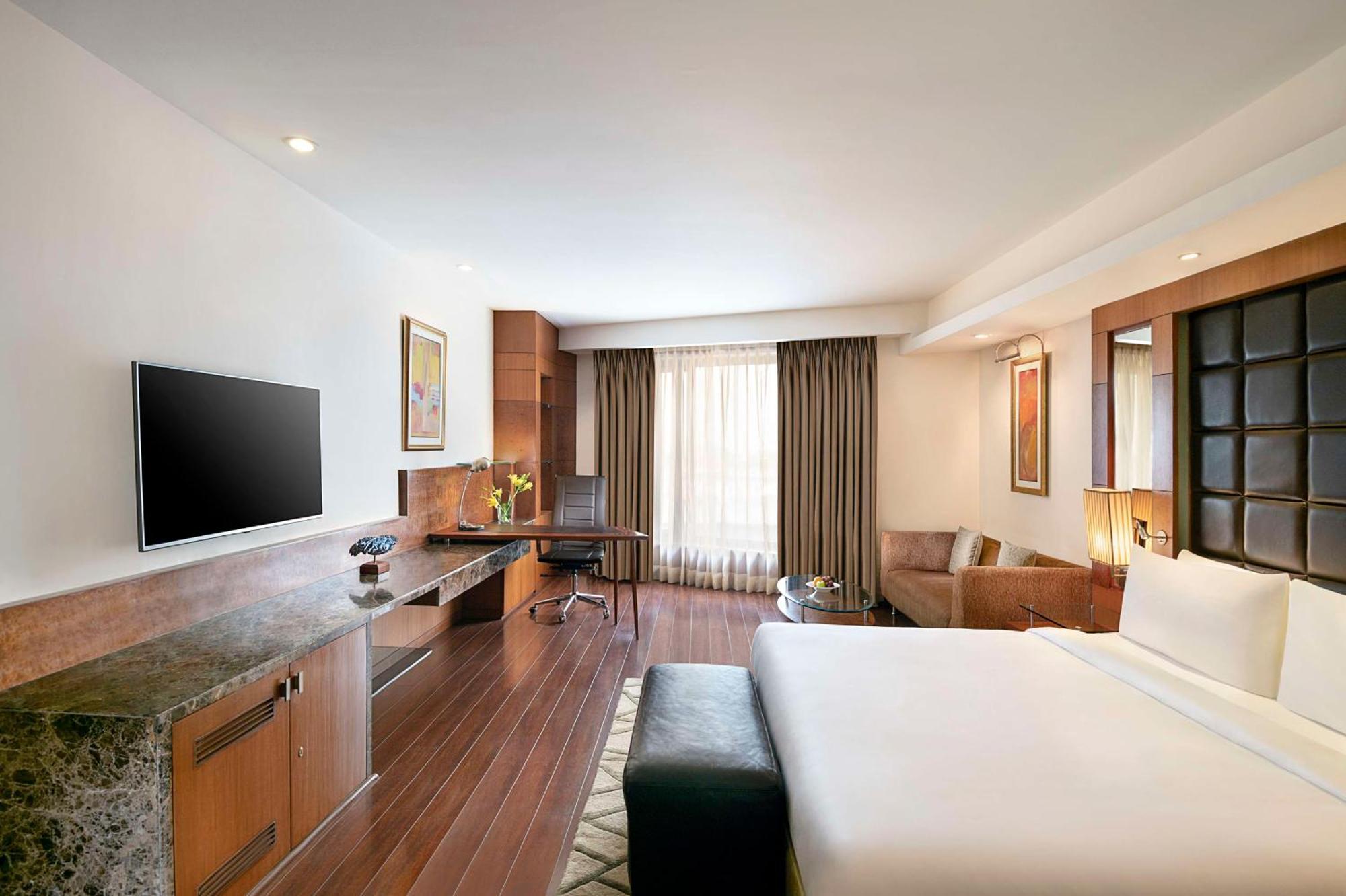 Deluxe Room with Happy Hours 01:00 PM to 06:00 PM, one way Airport Transfers and Free Pick up and drop to Worldmark Aerocity (subject to car availability),1695747668:JPEG